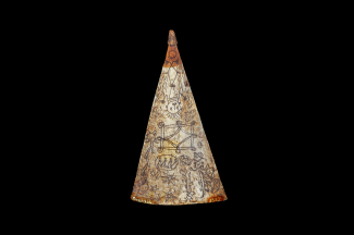 A triangular amulet on a black background