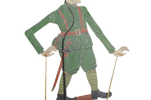 A leather puppet depicting a man wearing green military style garb