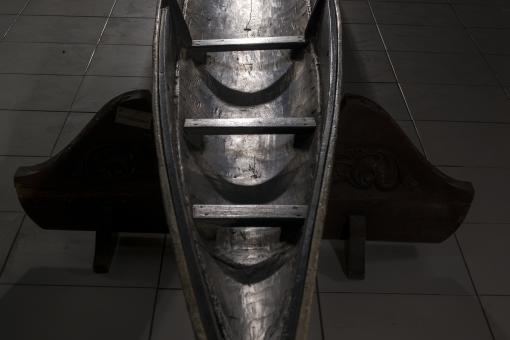 Image of a Dayak Long Boat showing the inside of the boat from an aerial vantage point.