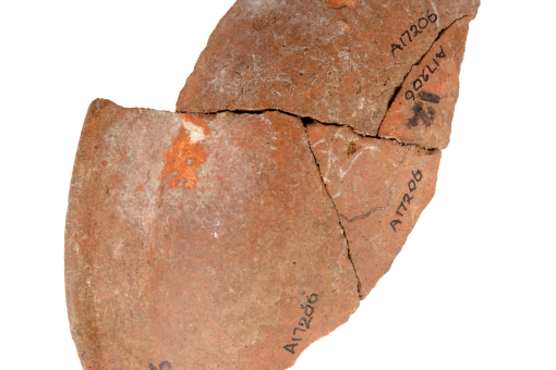 Various pottery sherds that have been pieced back together, on a white background